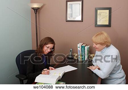 Doctor of Natural Medicine looks at textbook to confirm patient??s medical diagnosis View Large Photo Image Stock Photo - Doctor of Natural Medicine looks at textbook to confirm patient??s medical diagnosis. Fotosearch