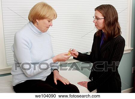 Doctor of Natural Medicine offers essential oil treatment to patient View Large Photo Image Stock Image - Doctor of Natural Medicine offers essential oil treatment to patient. Fotosearch