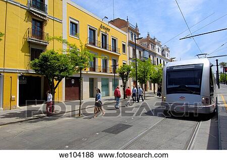 Stock Photo - Modern tramway ´electrico´ at San Fernando street, Seville, Andalusia, Spain. Fotosearch