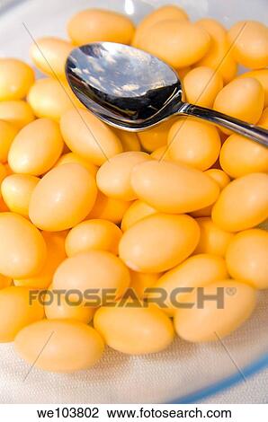 Orange wedding confetti, sugar almonds close up View Large Photo Image Stock Image - Orange wedding confetti, sugar almonds close up. Fotosearch
