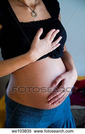 Pregnant woman holding belly View Large Photo Image Stock Photography - Pregnant woman holding belly. Fotosearch