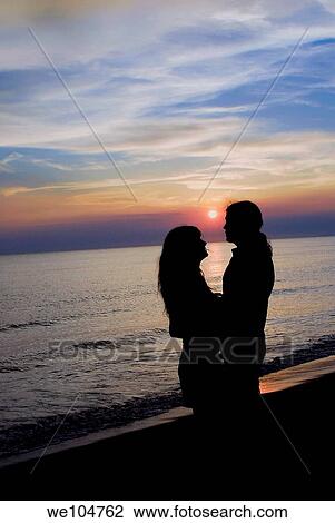 Romantic couple at sunset View Large Photo Image Stock Image - Romantic couple at sunset. Fotosearch