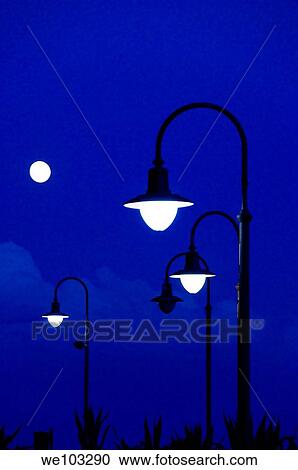 Street lamps at dusk View Large Photo Image Stock Image - Street lamps at dusk. Fotosearch