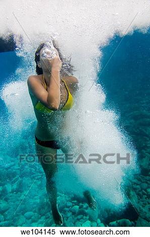Woman diving underwater View Large Photo Image Stock Photography - Woman diving underwater. Fotosearch