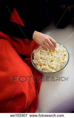 Woman eating popcorn on the sofa View Large Photo Image Stock Photo - Woman eating popcorn on the sofa. Fotosearch