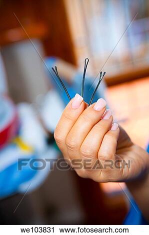 Woman holding three hairclips View Large Photo Image Stock Image - Woman holding three hairclips. Fotosearch