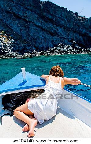 Woman leaning overboard on boat looking at the sea water Pantelleria island, Sicily, Italy View Large Photo Image Stock Image - Woman leaning overboard on boat looking at the sea water Pantelleria island, Sicily, Italy. Fotosearch