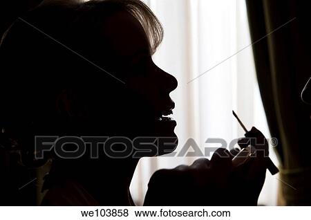 Woman putting on make up View Large Photo Image Stock Photo - Woman putting on make up. Fotosearch