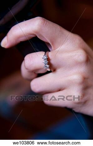 Woman wearing an engagement wing View Large Photo Image Stock Photograph - Woman wearing an engagement wing. Fotosearch