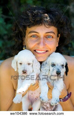 Stock Photograph - young girl with a dog puppies of the English Setter breed. Fotosearch