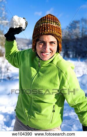 young woman playing with snowballs in a snow covered landscape View Large Photo Image Stock Image - young woman playing with snowballs in a snow covered landscape. Fotosearch