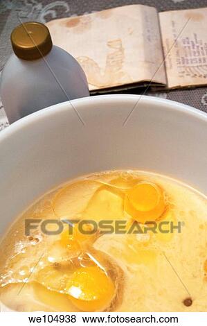 A bowl of raw baking ingredients as well as a recipe book on a table View Large Photo Image Stock Photo - A bowl of raw baking ingredients as well as a recipe book on a table. Fotosearch