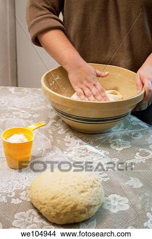 A woman´s hand folding cookie dough in a bowl View Large Photo Image Picture - A woman´s hand folding cookie dough in a bowl. Fotosearch