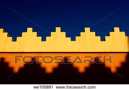 Abstract pattern of crenellations of yellow orange and blue sky Morocco View Large Photo Image Stock Image - Abstract pattern of crenellations of yellow orange and blue sky Morocco. Fotosearch