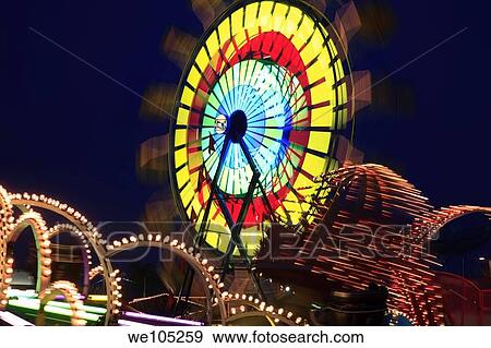 Amusement Rides with Movement Blur in the evening at the Kentucky State Fair Midway Louisville Kentucky View Large Photo Image Stock Photo - Amusement Rides with Movement Blur in the evening at the Kentucky State Fair Midway Louisville Kentucky. Fotosearch