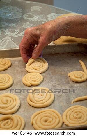 An old woman´s hand placing cookies on a baking tray View Large Photo Image Stock Photography - An old woman´s hand placing cookies on a baking tray. Fotosearch