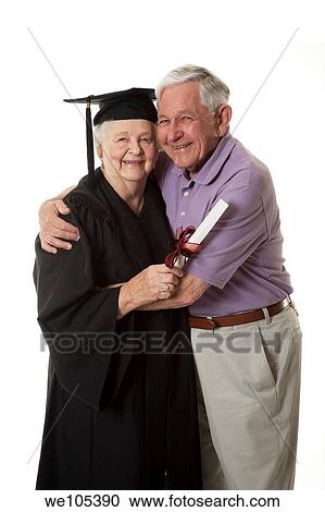 Beauitiful Caucasian woman in a black graduation gown with her husband View Large Photo Image Stock Image - Beauitiful Caucasian woman in a black graduation gown with her husband. Fotosearch