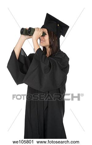 Beautiful Caucasian woman wearing in a black graduation gown and looking through binoculars View Large Photo Image Stock Image - Beautiful Caucasian woman wearing in a black graduation gown and looking through binoculars. Fotosearch