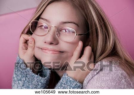 Blond preteen girl with glasses, her cheeks being held by her sister View Large Photo Image Stock Photo - Blond preteen girl with glasses, her cheeks being held by her sister. Fotosearch