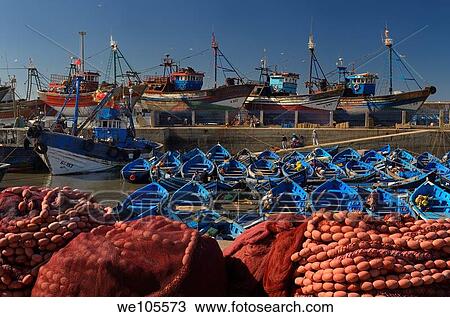 Blue fishing boats and red nets in the morning at the marine port of Essaouira Morocco View Large Photo Image Stock Image - Blue fishing boats and red nets in the morning at the marine port of Essaouira Morocco. Fotosearch