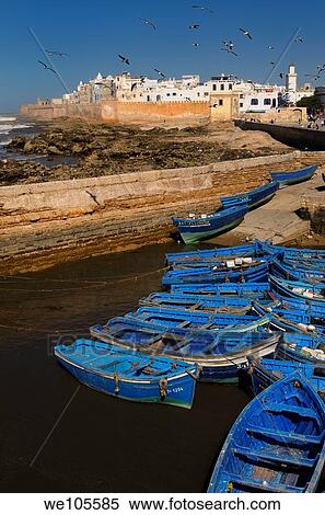 Blue fishing boats and the sea bastion ramparts of Essaouira Morocco View Large Photo Image Stock Photography - Blue fishing boats and the sea bastion ramparts of Essaouira Morocco. Fotosearch