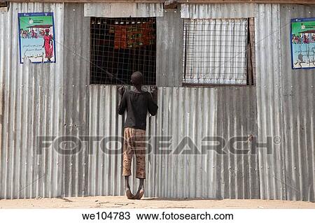 boy looking in shop window of registration place for vote on referendum, Juba Sudan, Dec 2010 View Large Photo Image Stock Image - boy looking in shop window of registration place for vote on referendum, Juba Sudan, Dec 2010. Fotosearch
