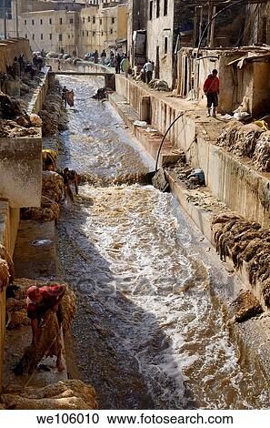 Busy Fes tannery after Eid al Adha with workers washing pelts in the Fes river Morocco View Large Photo Image Stock Image - Busy Fes tannery after Eid al Adha with workers washing pelts in the Fes river Morocco. Fotosearch
