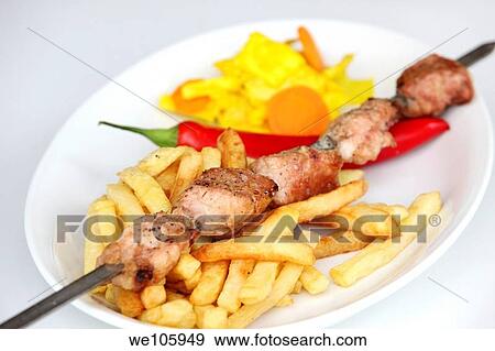 Char grilled turkey Shish Kebab Skewer with french fries and chilli View Large Photo Image Stock Photo - Char grilled turkey Shish Kebab Skewer with french fries and chilli. Fotosearch