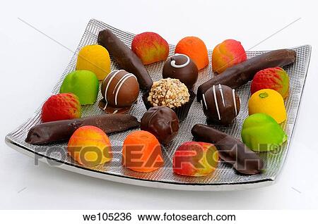Chocolate truffles candied orange rind and marzipan candies on a silver plate on white View Large Photo Image Stock Photograph - Chocolate truffles candied orange rind and marzipan candies on a silver plate on white. Fotosearch