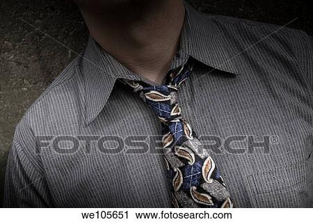 Close-up of a young man with a loosened tie View Large Photo Image Stock Image - Close-up of a young man with a loosened tie. Fotosearch