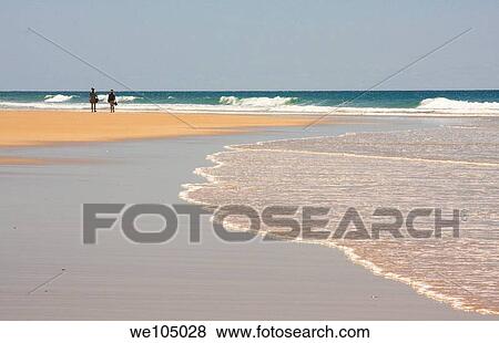 Couple walking on beach at Cap Ferret, France View Large Photo Image Stock Photo - Couple walking on beach at Cap Ferret, France. Fotosearch