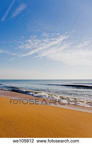 Early morning light on the rich colored sand and surf of the beach View Large Photo Image Stock Image - Early morning light on the rich colored sand and surf of the beach. Fotosearch