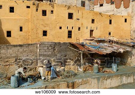 Fes leather tannery workers painting raw hides with blue chromium solution by Wadi Fes Morocco View Large Photo Image Stock Photo - Fes leather tannery workers painting raw hides with blue chromium solution by Wadi Fes Morocco. Fotosearch