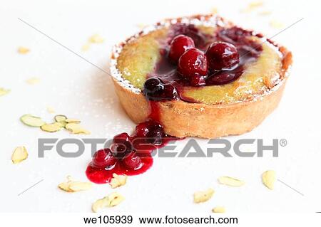 Stock Photo - Fruit tart decorated with forest berry sauce. Fotosearch