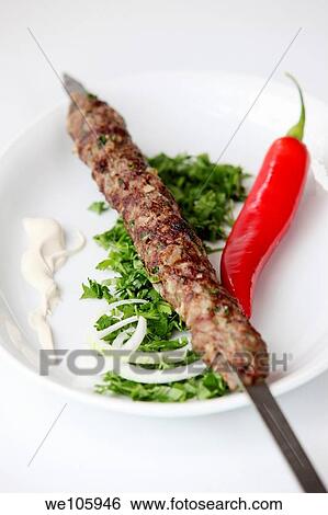 Lamb Kebab skewer on a plate View Large Photo Image Stock Photograph - Lamb Kebab skewer on a plate. Fotosearch