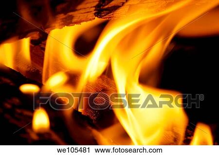 Stock Image - Logs burning in an outdoor campfire. Fotosearch