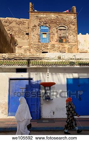 Modern telephone in an ancient Essaouira Medina street with two Morrocan women View Large Photo Image Stock Image - Modern telephone in an ancient Essaouira Medina street with two Morrocan women. Fotosearch