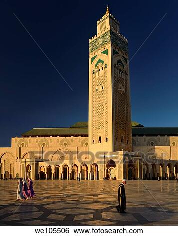 Moroccan man and women walking on the plaza of the Hassan II Mosque Casablanca at sunset, Morocco View Large Photo Image Stock Photograph - Moroccan man and women walking on the plaza of the Hassan II Mosque Casablanca at sunset, Morocco. Fotosearch