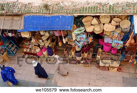 Moroccans in djellabas walking the Essaouira Medina with basket shop viewed from above, Morocco View Large Photo Image Stock Photo - Moroccans in djellabas walking the Essaouira Medina with basket shop viewed from above, Morocco. Fotosearch