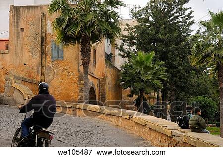Motorcyclist and two schoolboys at the East entrance gate to the Old Medina Casablanca, Morocco View Large Photo Image Stock Photo - Motorcyclist and two schoolboys at the East entrance gate to the Old Medina Casablanca, Morocco. Fotosearch
