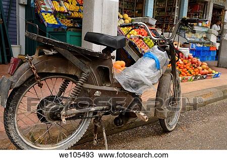 Old motorbike parked at grocery store in the outdoor Casablanca new market, Morocco View Large Photo Image Stock Image - Old motorbike parked at grocery store in the outdoor Casablanca new market, Morocco. Fotosearch
