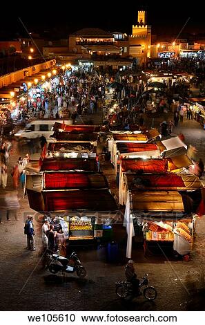 Overview of crowds at food booths and shops at night in Place Djemaa el Fna square Marrakech Morocco View Large Photo Image Stock Image - Overview of crowds at food booths and shops at night in Place Djemaa el Fna square Marrakech Morocco. Fotosearch