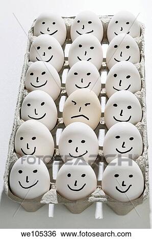 Package of bright backlit eggs with smiling faces except for one grumpy sad face View Large Photo Image Stock Photograph - Package of bright backlit eggs with smiling faces except for one grumpy sad face. Fotosearch