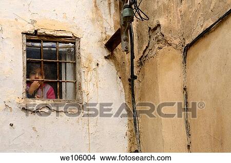 Pensive young girl staring out a small window in the el Bali Medina of Fes Morocco View Large Photo Image Picture - Pensive young girl staring out a small window in the el Bali Medina of Fes Morocco. Fotosearch