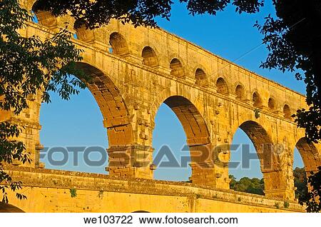 Stock Image - Pont du Gard Roman aqueduct at dawn, Gard, Languedoc-Roussillon, France. Fotosearch