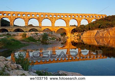 Pont du Gard Roman aqueduct at dawn, Gard, Languedoc-Roussillon, France View Large Photo Image Stock Photograph - Pont du Gard Roman aqueduct at dawn, Gard, Languedoc-Roussillon, France. Fotosearch