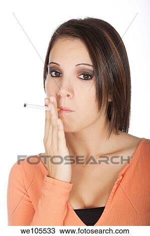 Stock Image - Portrait of beautiful woman, she is smoking cigarette. Fotosearch