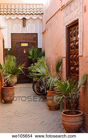 Red ochre alleyway with doors and palm planters in the Souk of Marrakech Morocco View Large Photo Image Picture - Red ochre alleyway with doors and palm planters in the Souk of Marrakech Morocco. Fotosearch