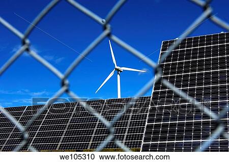 Security of installations for the generation of renewable energy, solar panels and a wind turbine behind a meshed security fence, solar power station Mont Soleil, St Imier, Switzerland View Large Photo Image Stock Image - Security of installations for the generation of renewable energy, solar panels and a wind turbine behind a meshed security fence, solar power station Mont Soleil, St Imier, Switzerland. Fotosearch