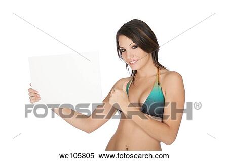Sexy Caucasian woman wearing a bikini and holding a blank sign View Large Photo Image Stock Photography - Sexy Caucasian woman wearing a bikini and holding a blank sign. Fotosearch